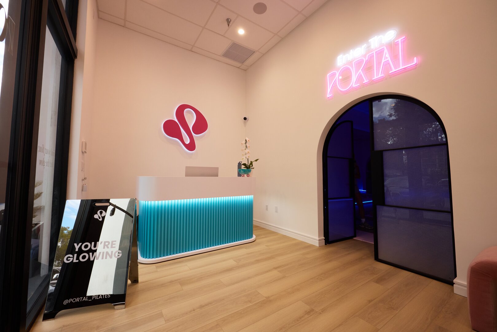 Portal Pilates reception with neon sign